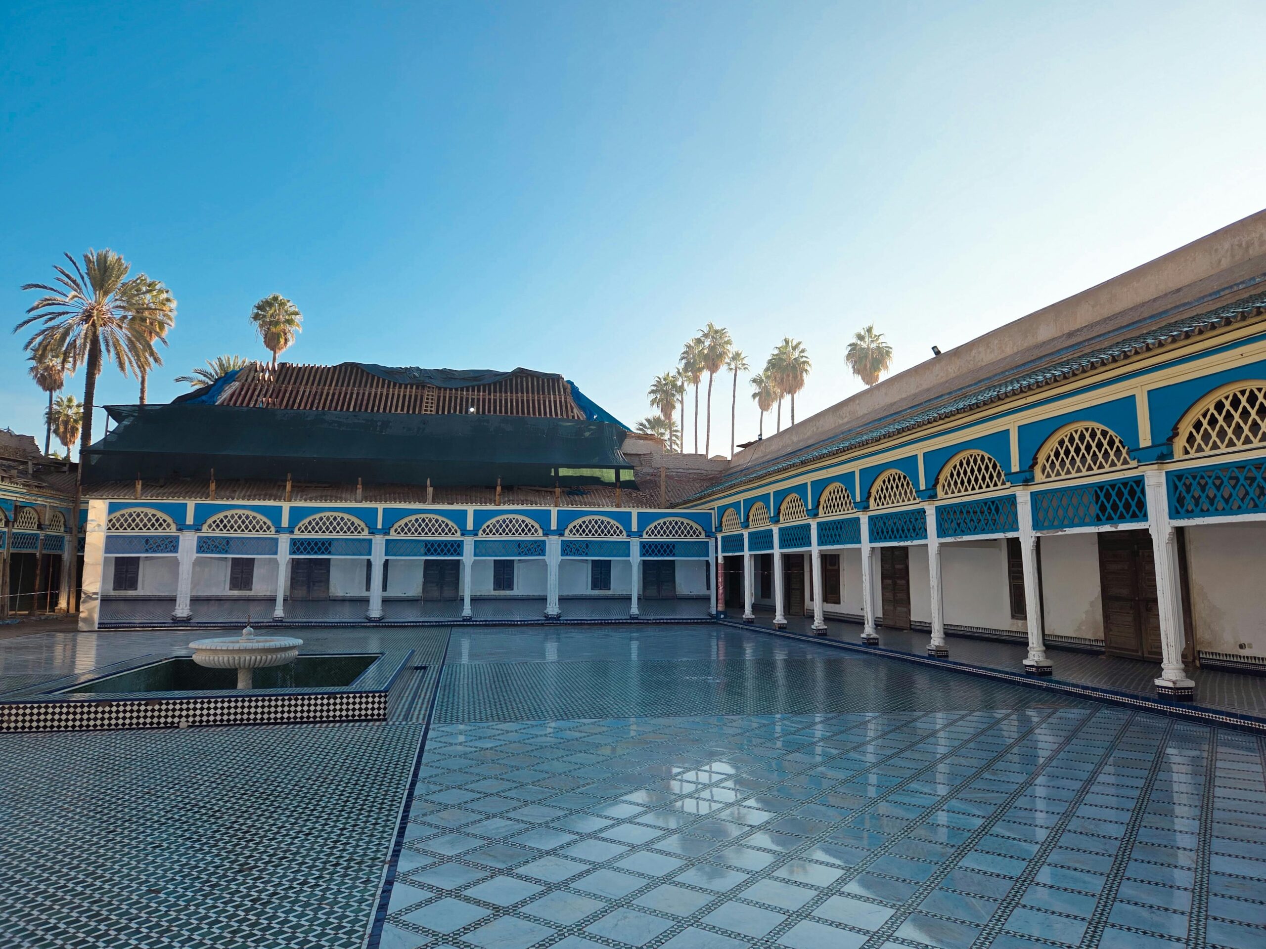 Sunlit courtyard of the Bahia Palace in Marrakech with stunning Moroccan architecture.